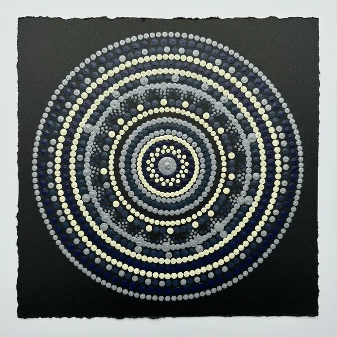Concentric circles on a mandala where large and small dots alternate to create a rippling effect.