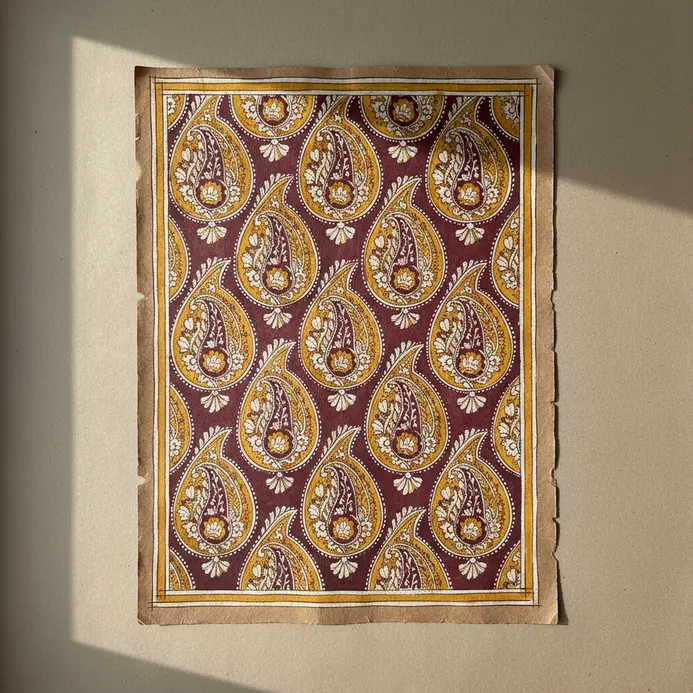 A single detailed paisley shape, resembling a mango, filled with small decorative patterns.