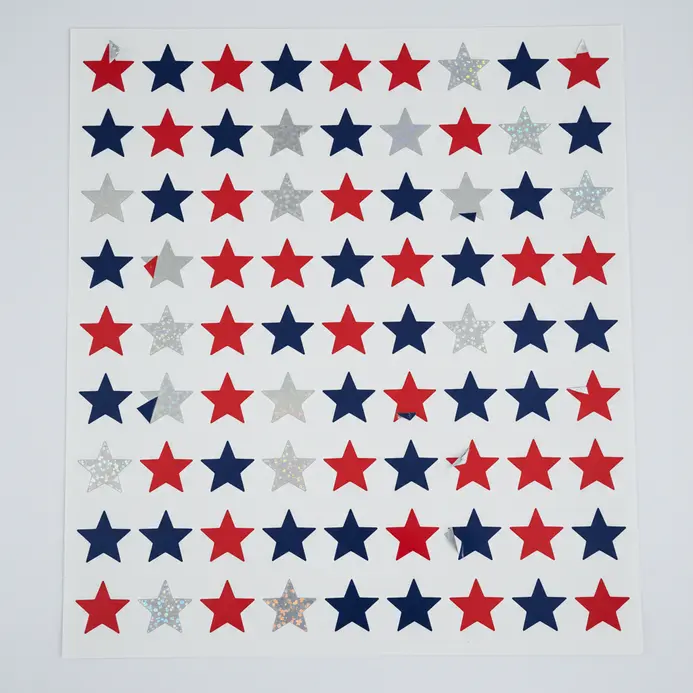 A large poster board is covered in 100 identical die-cut star stickers.