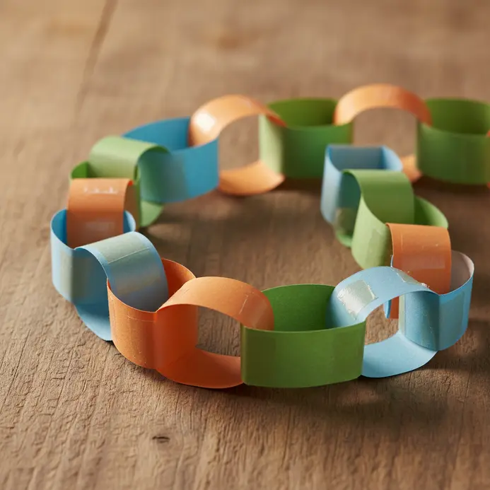 A long decorative paper chain made from 100 individually linked strips of colored paper.