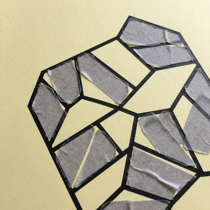 A scrapbook page background created with strips of geometric washi tape forming triangles and diagonal lines.