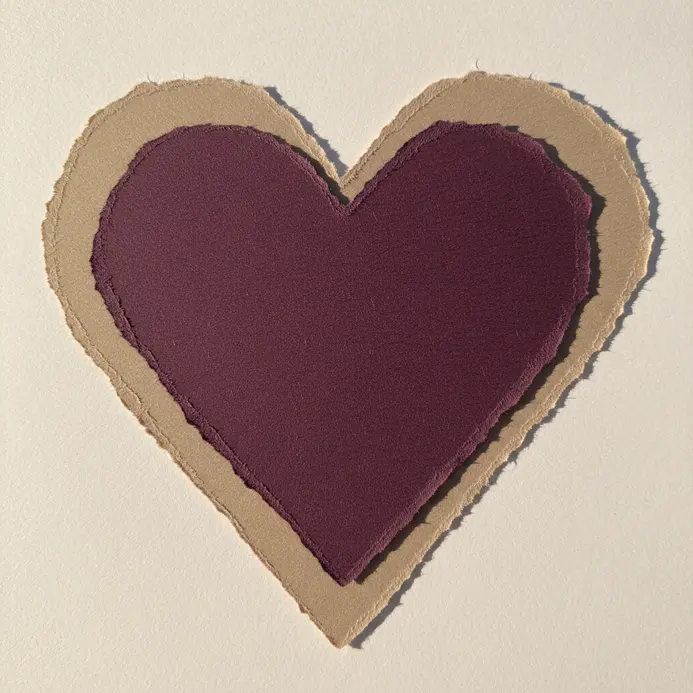 Three layers of different colored paper with roughly torn edges, stacked and offset beneath a photo.