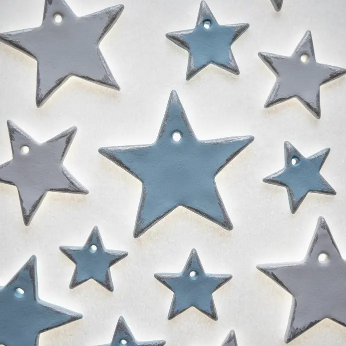 Three delicate air dry clay star shapes, each with a small hole for hanging.
