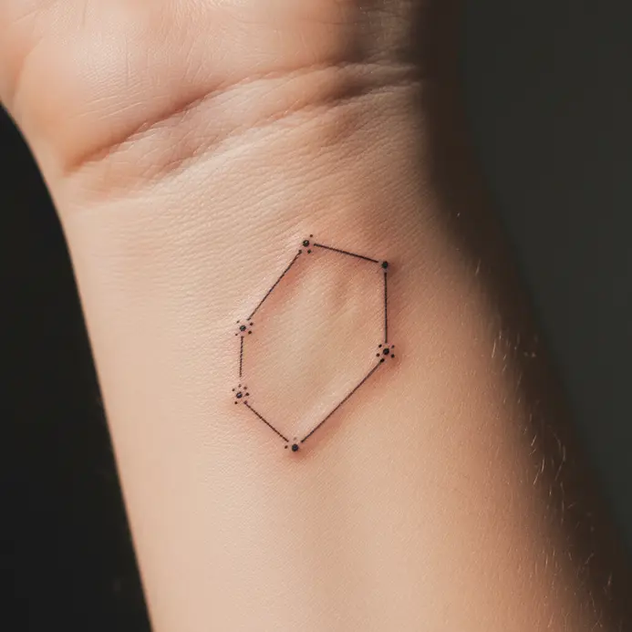 A delicate, single-needle Gemini star map tattooed on the inner wrist.