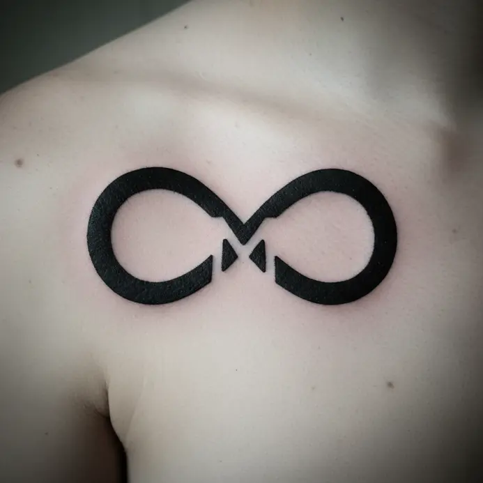 A tattoo on the shoulder where an infinity symbol is inked, with the negative space inside clearly forming a letter M.