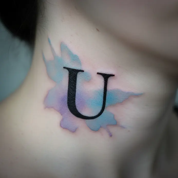 A solid black letter U on the side of the neck with soft blue and purple watercolor washes fading out behind it.