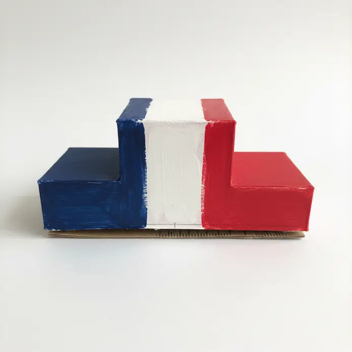 A small podium with three levels made from cardstock, colored red, white, and blue.