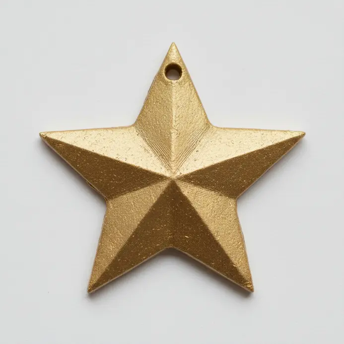 A five-pointed star cut from gold polymer clay, with a small hole punched at the top.