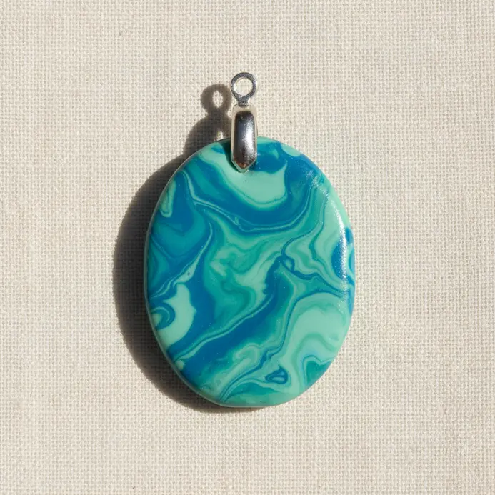A single, large flat bead with a marbled blue and green design, strung on a black cord.