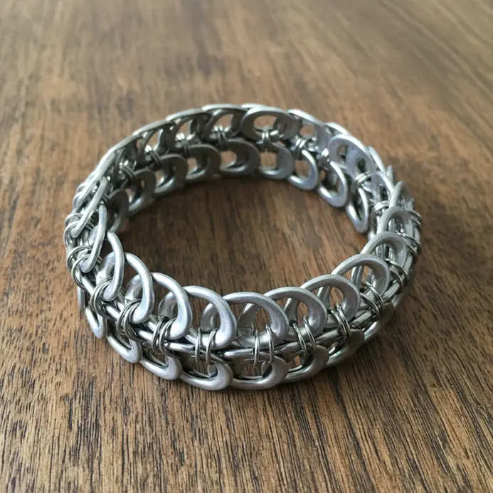 A simple, chain-link style bracelet constructed by connecting aluminum soda can tabs with small jump rings.