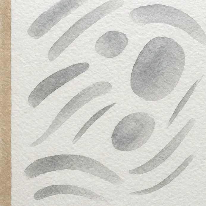 A close-up of textured, heavyweight watercolor paper taped to a board.