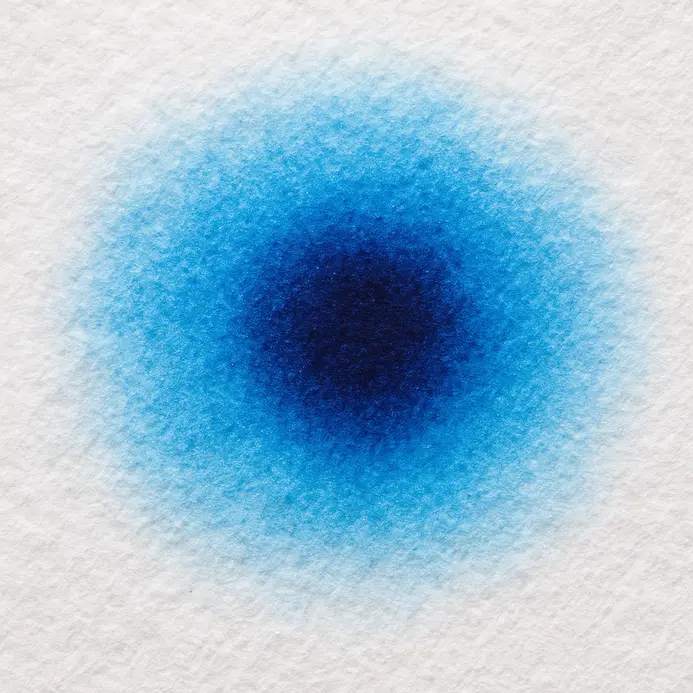A synthetic round brush loaded with rich blue watercolor pigment.