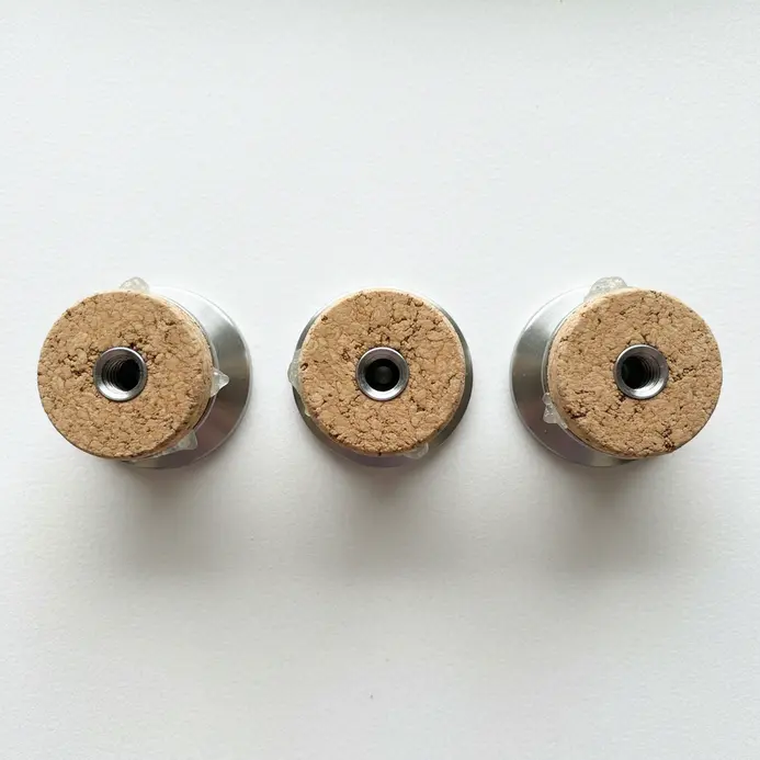 Three clean, minimalist drawer knobs made from whole wine corks with metal screw bases attached.