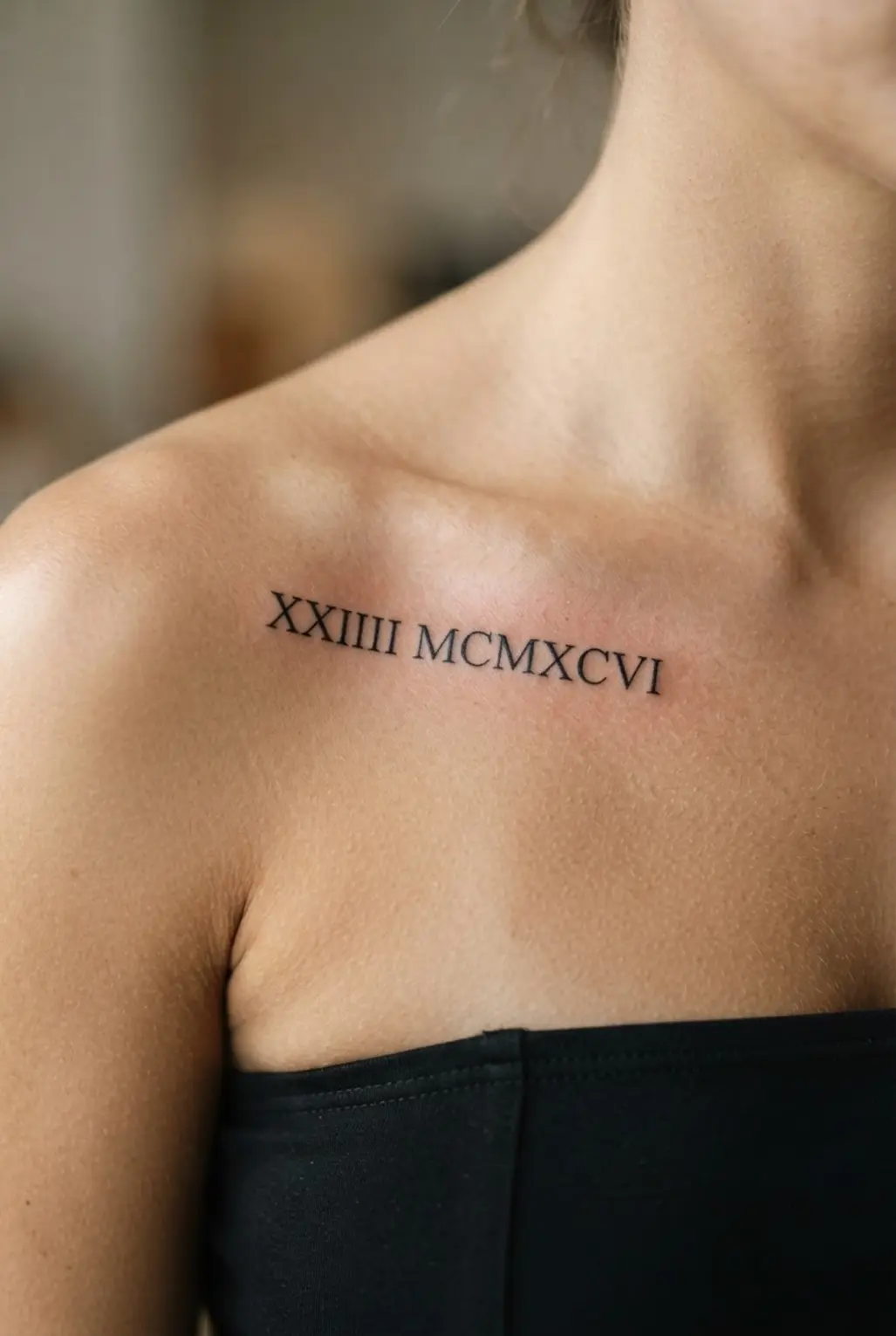 Minimalist Roman numeral tattoo along the collarbone with evenly spaced characters and fine black linework.