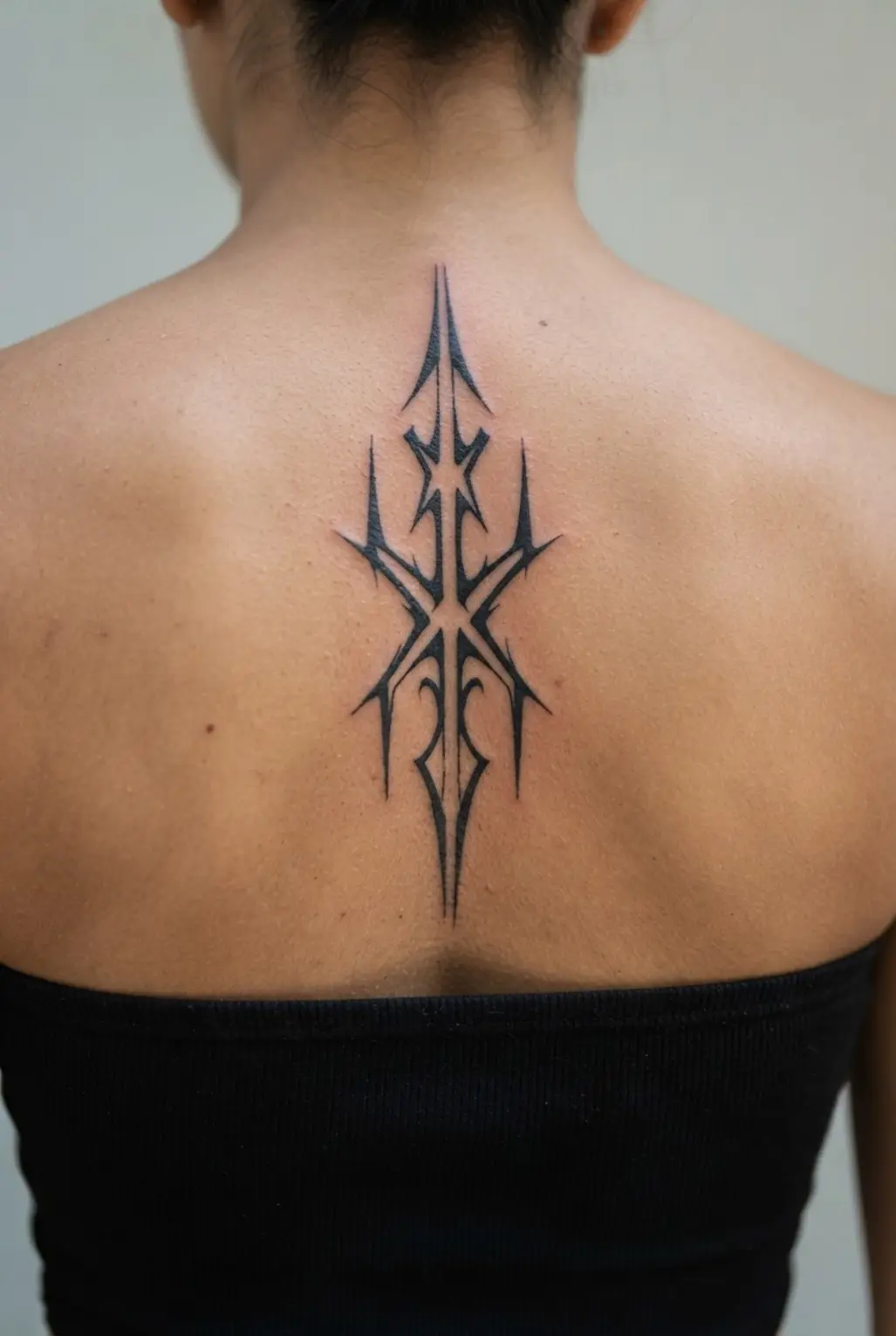 Cyber sigilism tattoo ideas shown as an angular spine sigil with sharp blackwork points and open gaps.