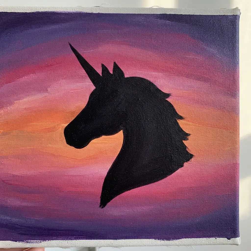 Easy unicorn painting ideas featuring a unicorn shadow portrait against orange, pink, and purple sunset layers.