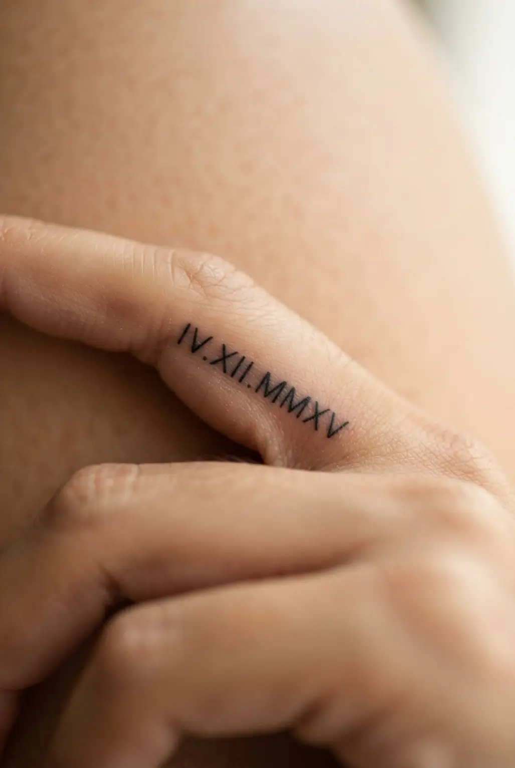 A short Roman numeral date sits along a finger in compact black lettering with an even baseline.