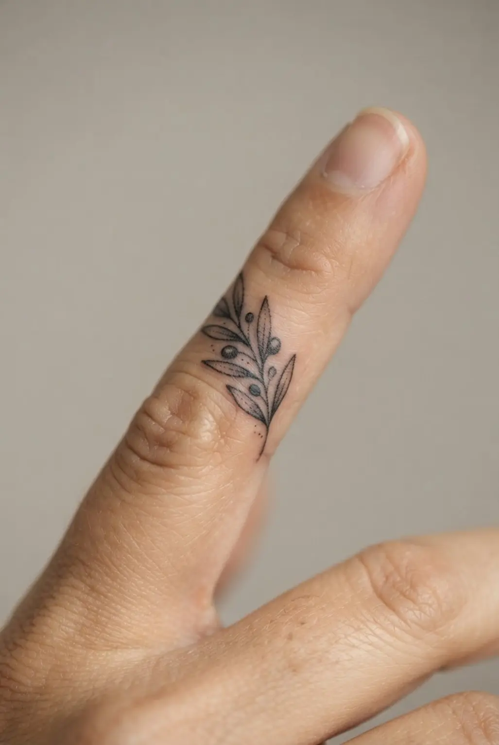 A seamless, full-coverage foundation application that corrects and conceals a dark finger tattoo.