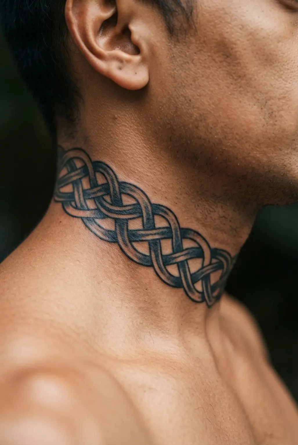 Celtic knot tattoo that wraps around the side of a man's neck.