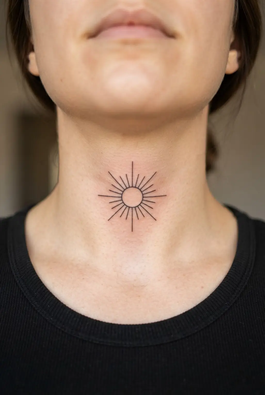 Single-line sun with slim rays below the jawline, a refined neck tattoo idea for women with open spacing.