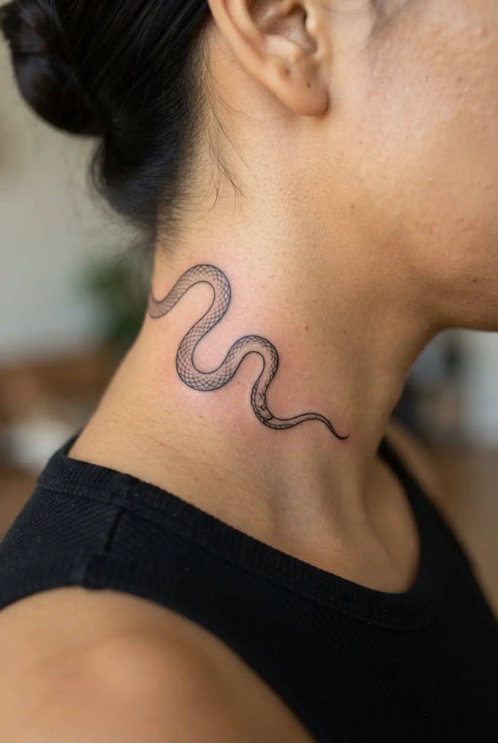 Fine-line snake curves around the side of the neck with a small head and evenly spaced scales.