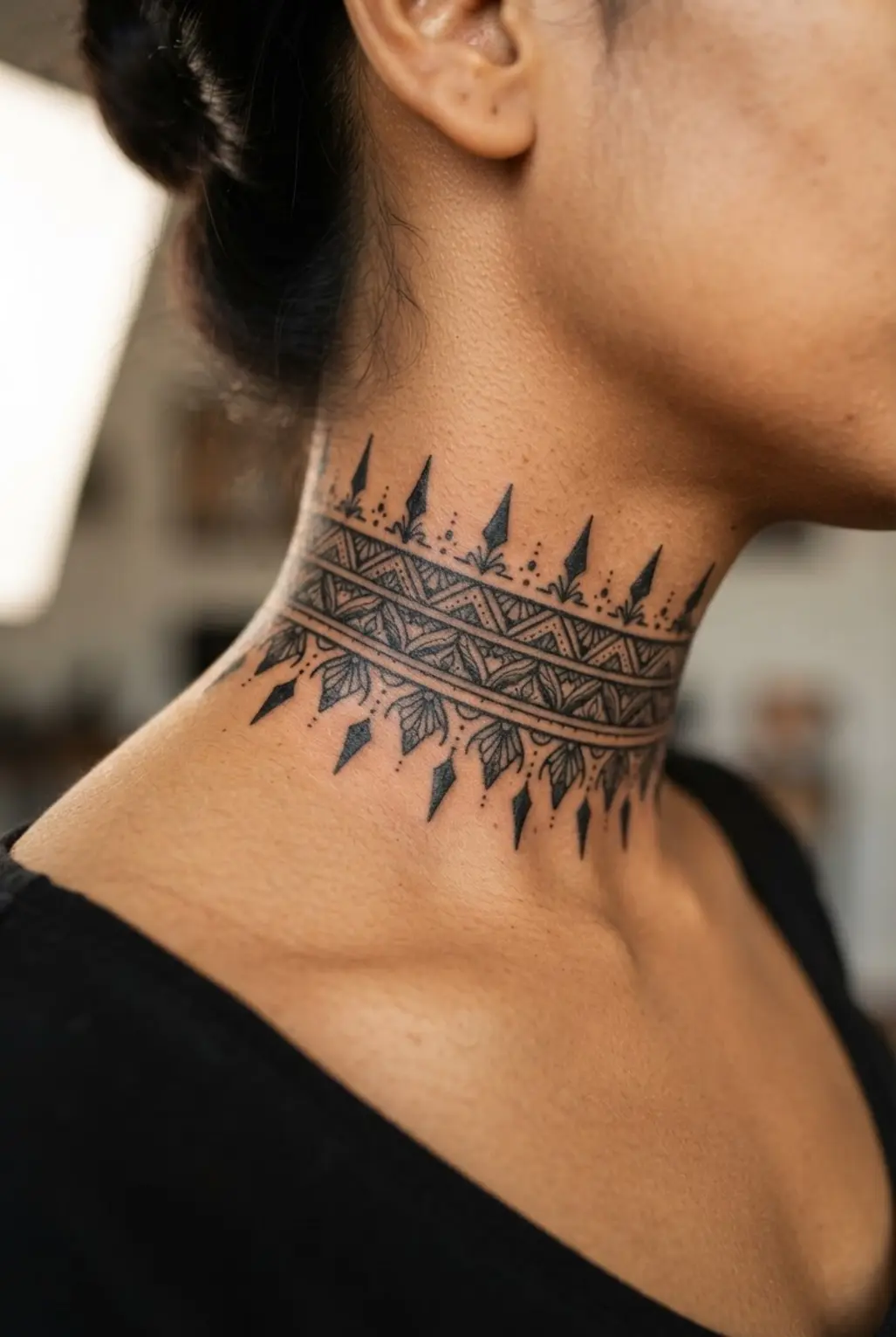 Ornamental blackwork choker band encircling the lower neck with repeating points and balanced open spaces.
