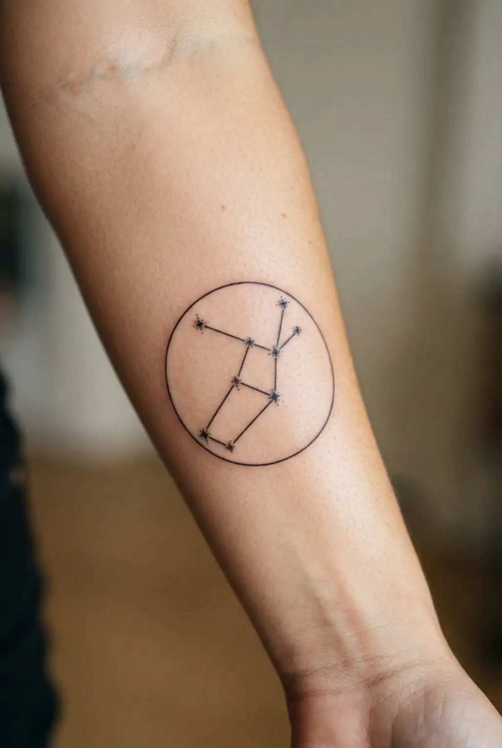 A modern geometric tattoo framing the Virgo constellation within a perfect circle.