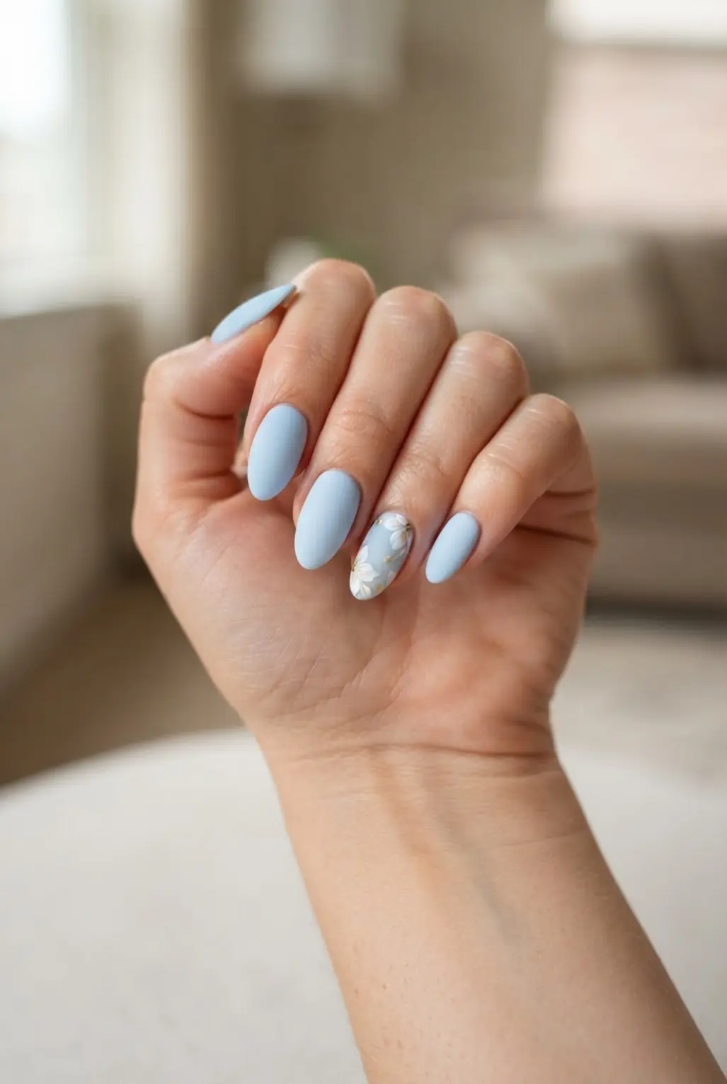 Pastel baby blue matte almond nails with smooth lacquer and a soft rounded tip shape.