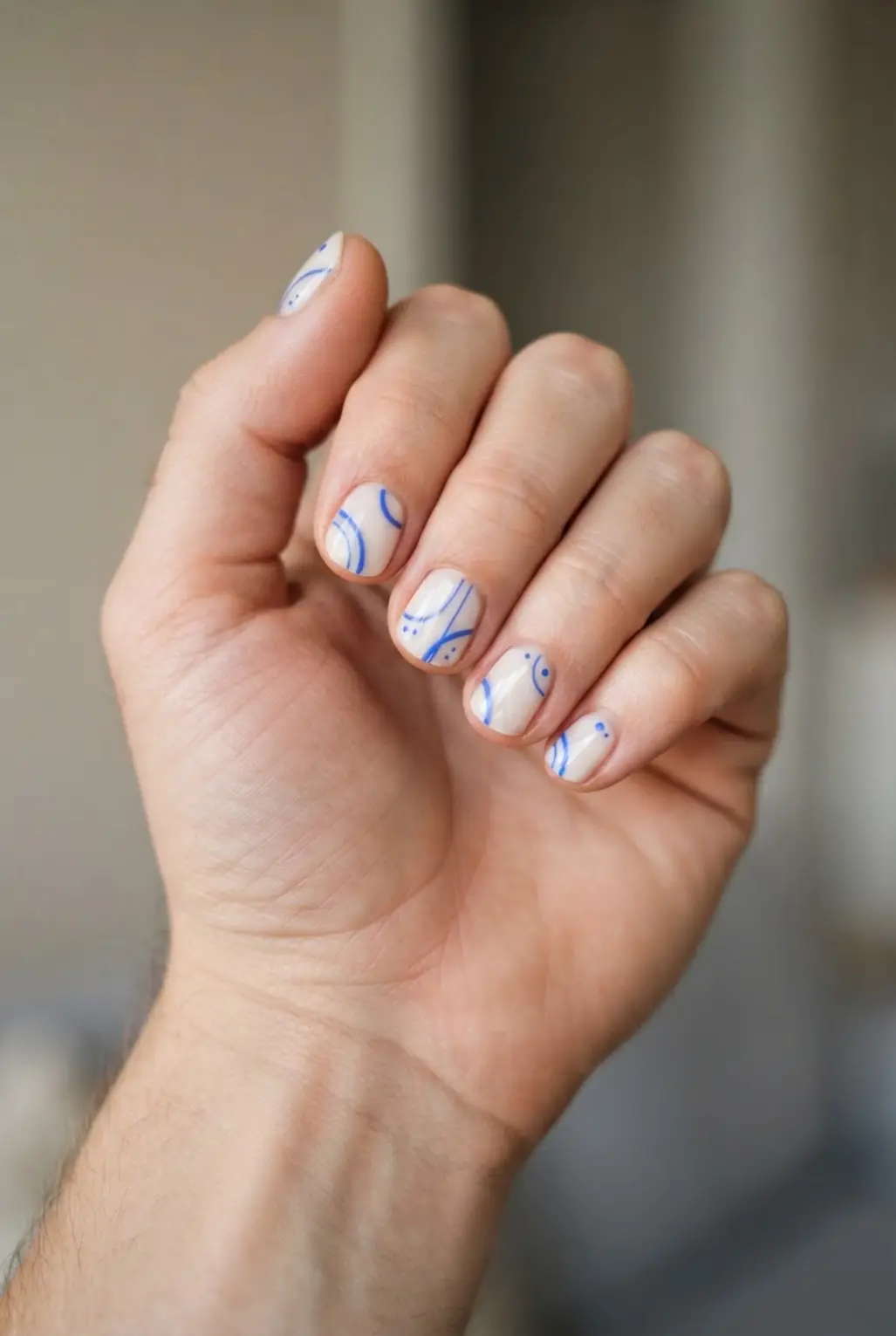 Cornflower blue minimalist line art nails with thin curves, tiny dots, and pale backgrounds.